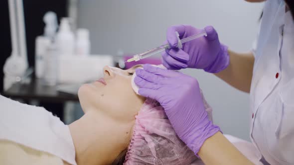 Client is Undergoing Mesotherapy in the Beauty Salon Using Injections 