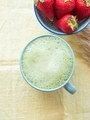 Matcha tea latte morning antioxidant hot drink in blue cup on yellow table cloth with pampas grass - PhotoDune Item for Sale