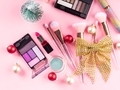 Christmas present with make up brushes, products on pink background. Closeup - PhotoDune Item for Sale