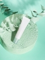 Skin care generic product cream tube on green podium - PhotoDune Item for Sale