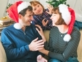 Mother, dad and son in santa caps on christmas holidays - PhotoDune Item for Sale