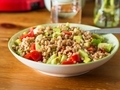 Fresh Italian farro spelt salad with tomatoes, avocado and cucumbers on wooden kitchen table.  - PhotoDune Item for Sale