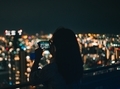 Girl taking a photo from the roof top at night - PhotoDune Item for Sale