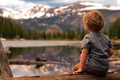 Small Boy On a Log Near a Mountain Lake - PhotoDune Item for Sale