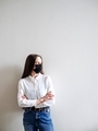 Confident business woman on the background of a white wall in a face mask. - PhotoDune Item for Sale