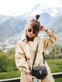 Stylish girl in glasses sits on the background of mountains in Georgia - PhotoDune Item for Sale