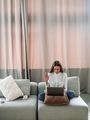 Modern girl in a white shirt in a stylish home interior works at a laptop - PhotoDune Item for Sale