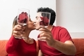 Latin couple kissing and holding wineglasses - PhotoDune Item for Sale
