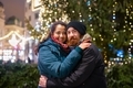 Happy young mulinational couple outdoor in a city center at Christmas - PhotoDune Item for Sale