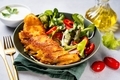 Close up of a plate with delicious breaded codfish with healthy salad - PhotoDune Item for Sale