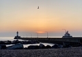 Sunrise in Duluth, Minnesota during the golden hour with two lighthouses, rocks and a pier  - PhotoDune Item for Sale