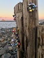The Love Locks in Duluth, Minnesota with sunset and lighthouse in background  - PhotoDune Item for Sale