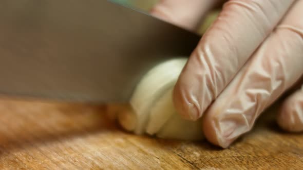 Clove of garlic cut in pieces on a wooden table.