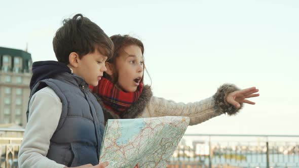School Boy and Girl Found a Place of Interest with the Help of Map