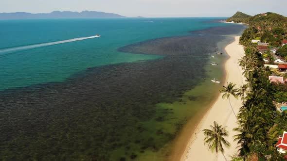 Road and Houses on Seashore. Drone View of Main Road and Coastal Cottages on Ko Samui Island