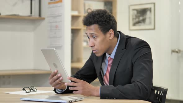 African Businessman in Shock While Using Tablet