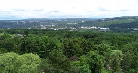 A push dolly of the town of Ithaca New York showing the valley, colleges, and lush forests.