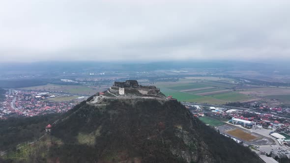 Stunning Aerial View of the Medieval Stone Fortress of Deva on a Cloudy Day