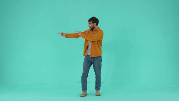 Cheerful Male Pointing Fingers Isolated in Studio