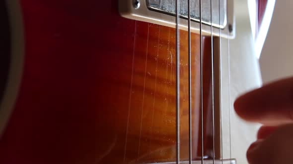 Fingerpicking nothing else matters on a cherry sunburst Les Paul guitar. Static close up shot