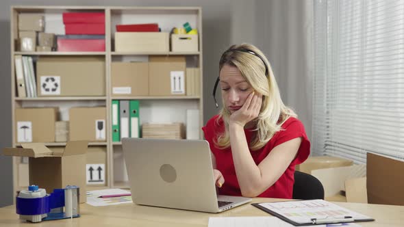 Tired Woman Works at Laptop Making Out Parcels for Delivery Yawns Falls Asleep in Workplace