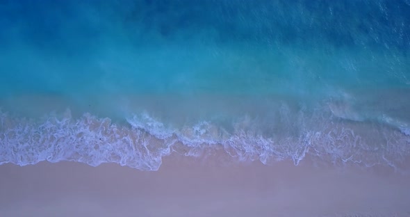 Tropical drone travel shot of a white sand paradise beach and blue sea background in hi res 4K