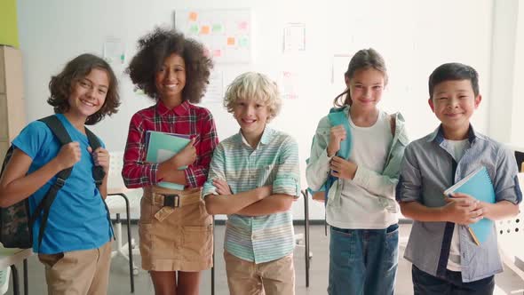 Happy Cheerful Smiling Diverse Schoolchildren in Classroom