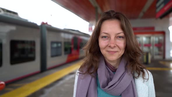 Lonely Abandoned Woman Is Standing on Platform and Looking on Leaving Train, Crying and Suffering