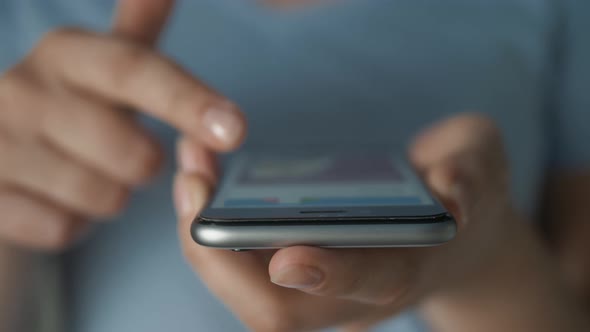 Young Woman Using Apps on a Mobile Touchscreen Smartphone