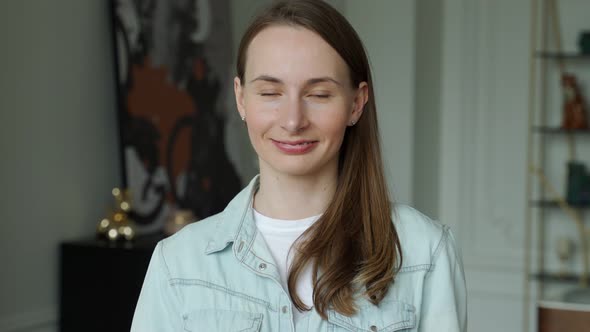 Portrait of a Young Handsome Woman in a Shirt Smiling at the Camera