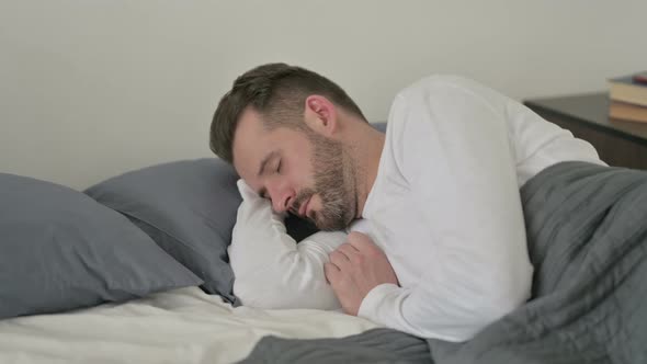 Man Sleeping in Bed Peacefully