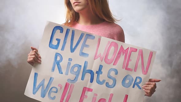 Portrait of Young Feminist Girl Holding Poster