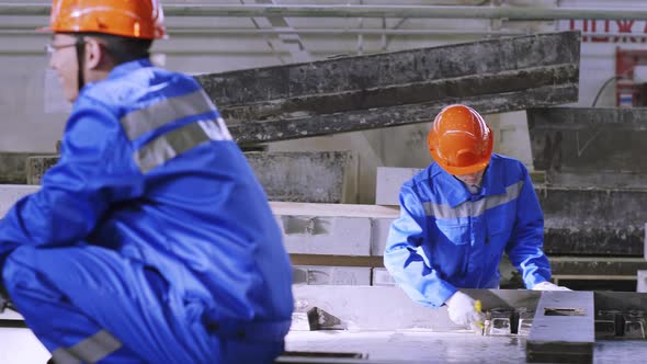 Multiracial team working at ferroconcrete factory