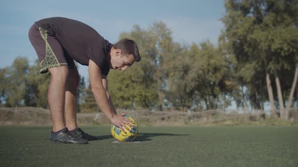 Football Player Placing Ball on Penalty Spot