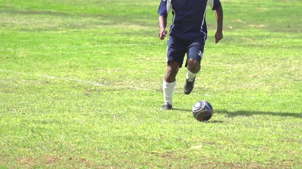 A man playing soccer on a grassy field