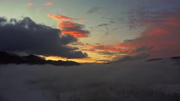 Dramatic sunset with colored clouds, magical moody nightfall, aerial