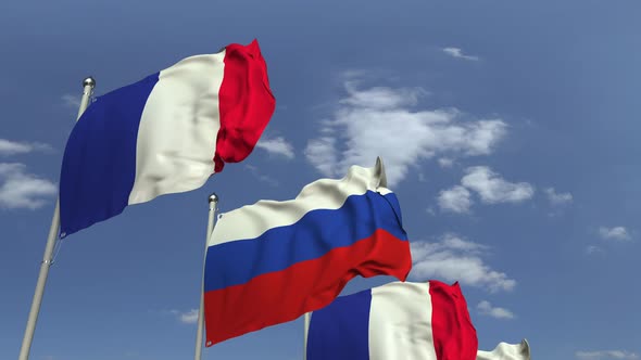 Flags of Russia and France Against Blue Sky alt