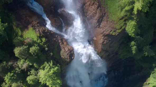 AERIAL LOWERING ROTATING to a dramatic waterfall in Switzerland, Iffigfall