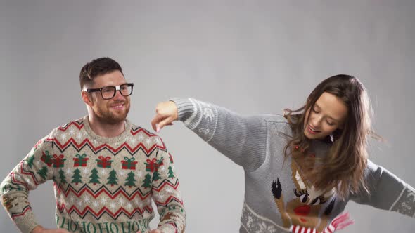 Happy Couple in Christmas Ugly Sweaters Dancing 29