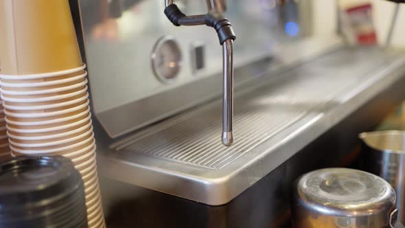 Blowing Hot Air Through the Steam Tube of a Professional Coffee Machine Before Frothing Milk in the