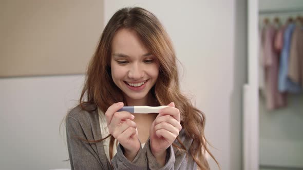 Happy Woman Holding Positive Pregnancy Test. Female Maternity. Baby Born Waiting