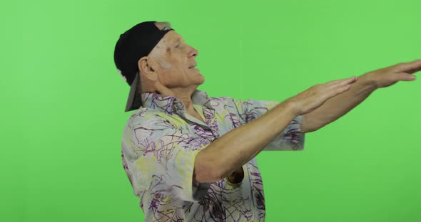 Senior Man Tourist in Colorful Shirt Dances. Handsome Old Man on Chroma Key