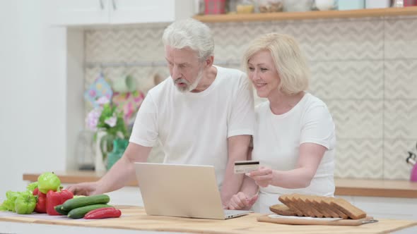 Loving Old Couple Making Online Payment on Laptop