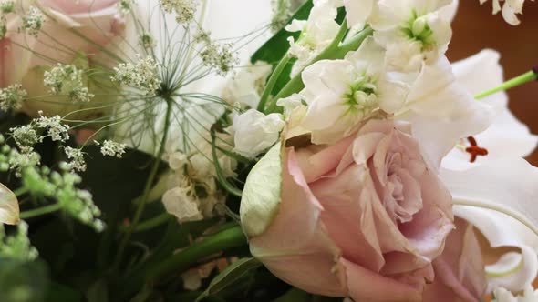 A valentines bouquet with white lilies and pink roses.