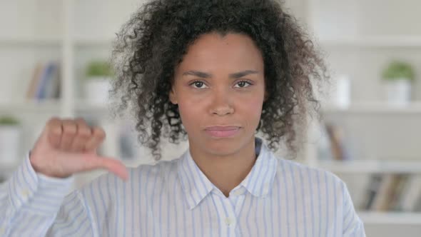 Disappointed African Woman Doing Thumbs Down