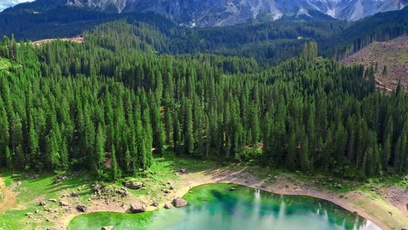 Aerial view of Carezza lake in Dolomites in summer, Italy