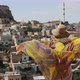Back View of Woman Wrapped in a Shawl Looks at the Old Town in Turkey - VideoHive Item for Sale