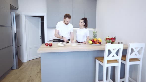Couple Cooking Together At Home In The Kitchen