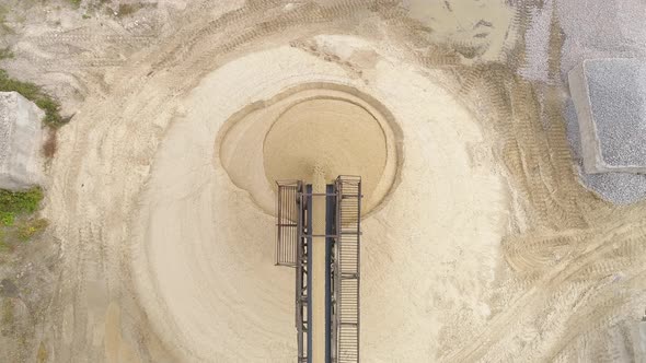 Aerial of a conveyor belt and a sand heap