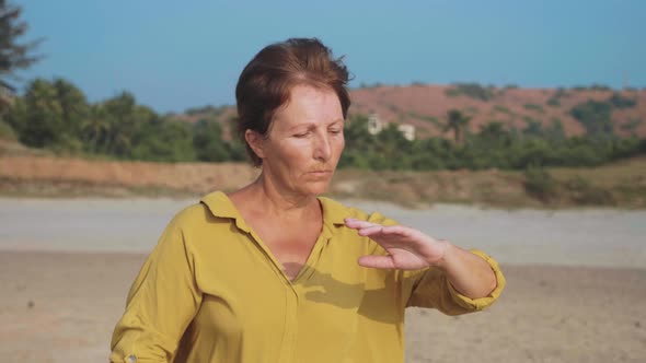 Senior Woman Practicing Taiji Gymnastic Outdoor in Slow Motion